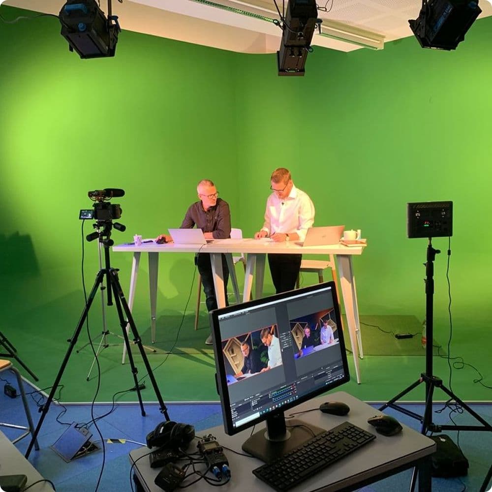 Two CyberElements colleagues filming in the company's video studio.